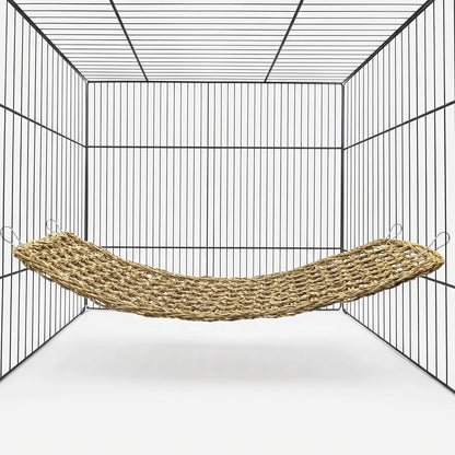 Empty woven natural-fibre hammock hung by four metal clips inside a black wire cage, shown against a plain white background. 1