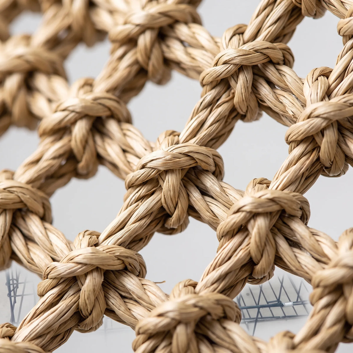 Close-up of the knotted, twisted natural fibre weave, showing the open mesh pattern and rope-like texture of the hammock. 3