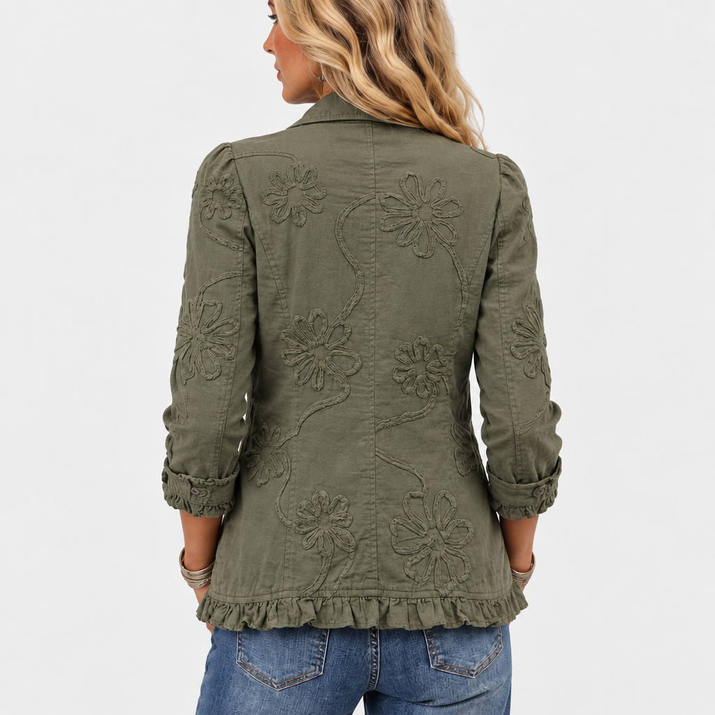 Back view of the olive green jacket with large embroidered flowers and trailing vines, finished with a ruffled hem. 5