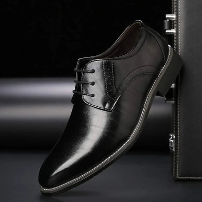 Single black glossy lace-up shoe with brogue perforations, tilted against a dark leather case on a dark studio background. 3