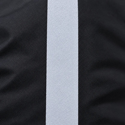 Close-up of the reflective strip on the black woven fabric, showing its fine, speckled, light grey surface. 5
