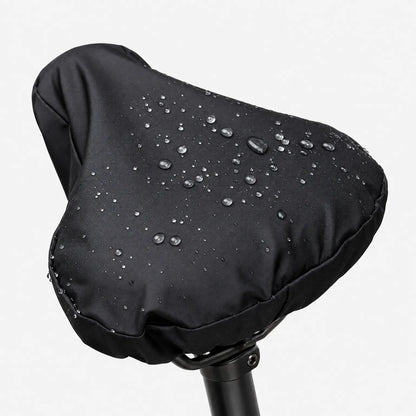 Close-up of the black side of the cover on a saddle, with raindrops sitting on the smooth fabric against a white background. 2