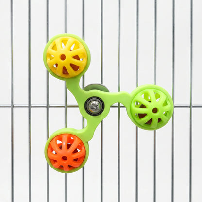 Green spinner toy with yellow, lime and orange balls mounted on metal cage bars, seen from the front against a white background. 5