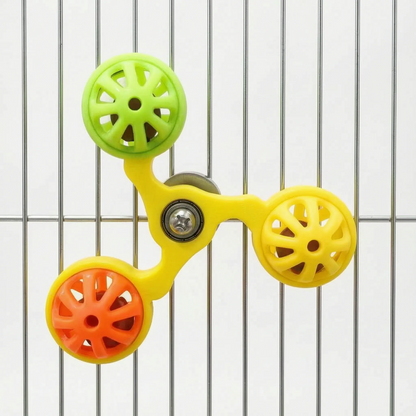 Yellow-framed version of the spinner toy with green, yellow and orange perforated balls, attached to metal cage bars. 6