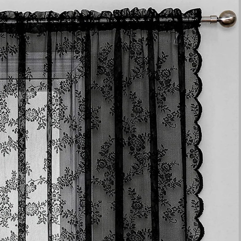 Close-up of the gathered rod pocket top of a black lace curtain on a silver rod with a round finial. 4