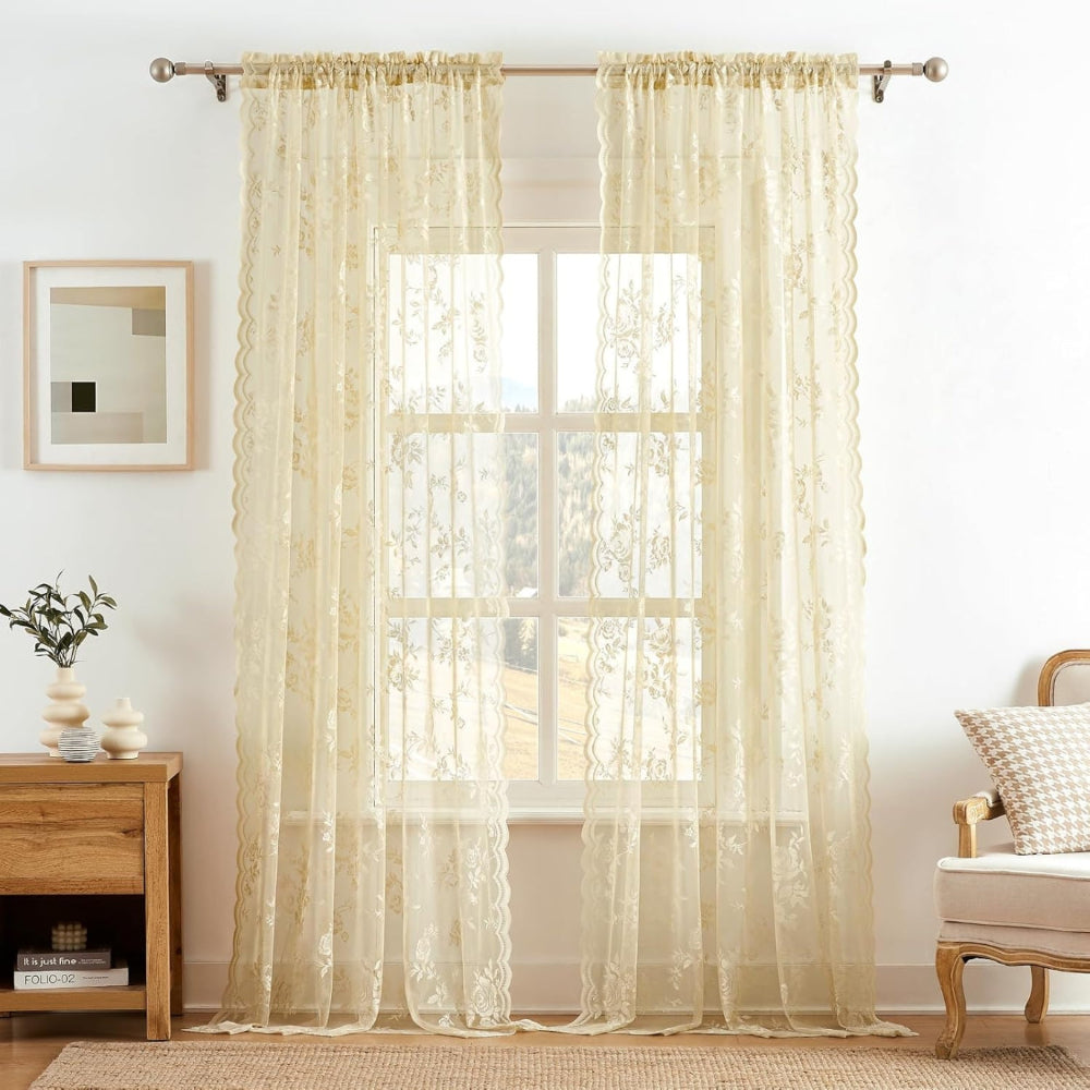 Pair of cream floral lace curtain panels with scalloped edges hung on a metal rod in a bright room. 8
