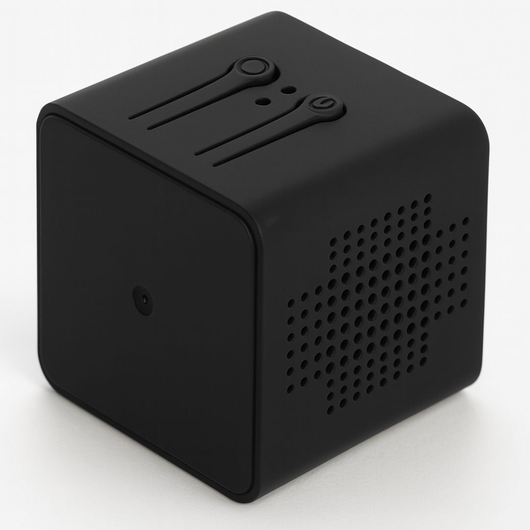 Rear three-quarter view of the matt black cube camera, showing the two top buttons and the perforated side panel. 6