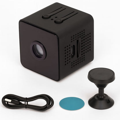 Black cube camera laid out with its USB cable, a round blue adhesive pad and a black magnetic mounting stand. 7