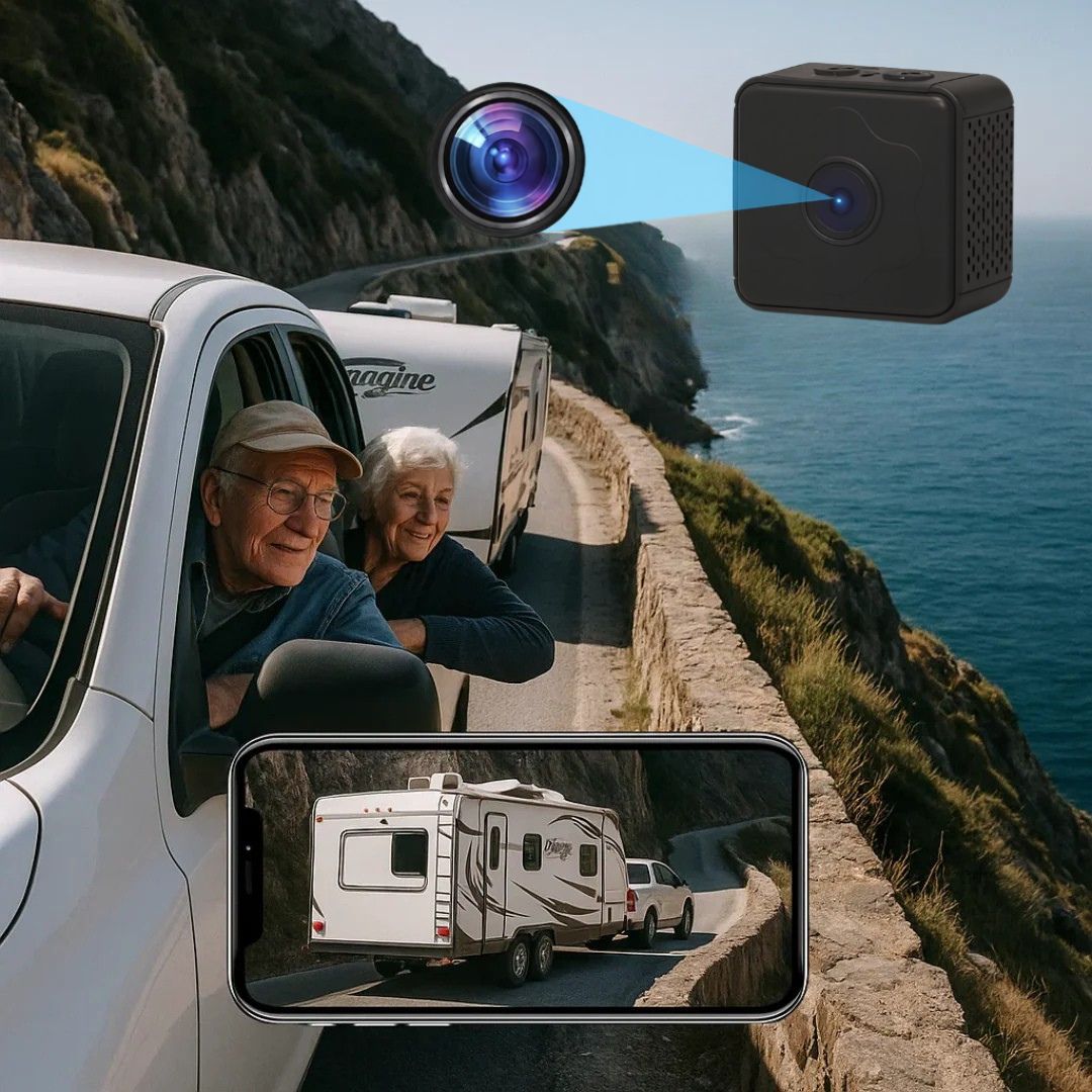 Older couple in a white pickup towing a caravan along a coastal road, with the small black camera and a phone showing the view behind. 1