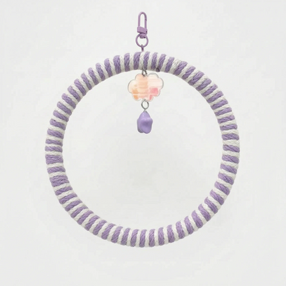 Ring swing wrapped in lilac and white striped rope, with a lilac clip, peach cloud charm and purple star bead. 7