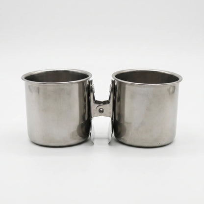 Two steel cups facing outwards, joined back to back by a single spring clip between them. 5