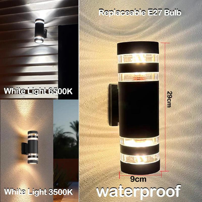 Long black cylindrical wall light with clear banded ends, dimensions marked, shown glowing in white and warm light on a wall. 9