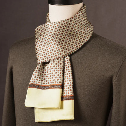 Cream silk scarf with small orange-red circular motifs, a brown patterned border and pale yellow ends, on a mannequin in an olive jumper. 9