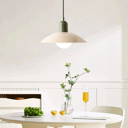 Cream pendant with green cap above a white round table set with grapes, lemon and champagne 6