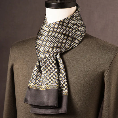 Dark grey silk scarf with small cream and gold floral medallions and a patterned border, on a mannequin in an olive jumper. 7