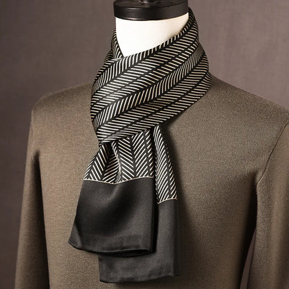 Black and cream herringbone-striped silk scarf with solid black ends, shown wrapped on a mannequin with an olive jumper. 4