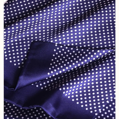 Close-up of the navy silk fabric with white polka dots, showing the glossy sheen and a folded plain navy edge. 27