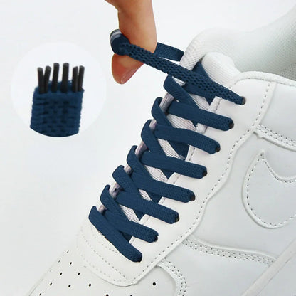 Navy flat elastic laces on a white trainer, with a close-up of the lace tips 1