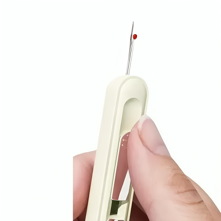 Hand holding the cream tool upright with the red-tipped ripper at the top, thumb on the slider 6