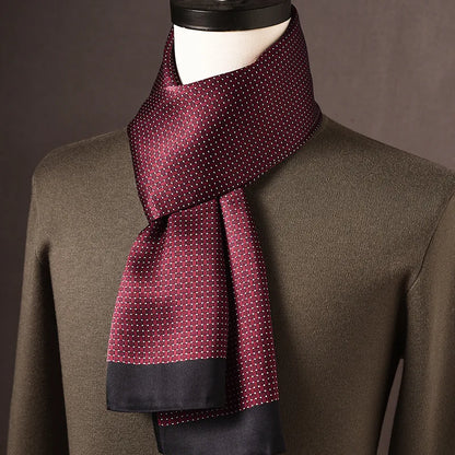 Burgundy silk scarf with a woven-look pattern, tiny white dots and navy ends, styled on a mannequin with an olive jumper. 6