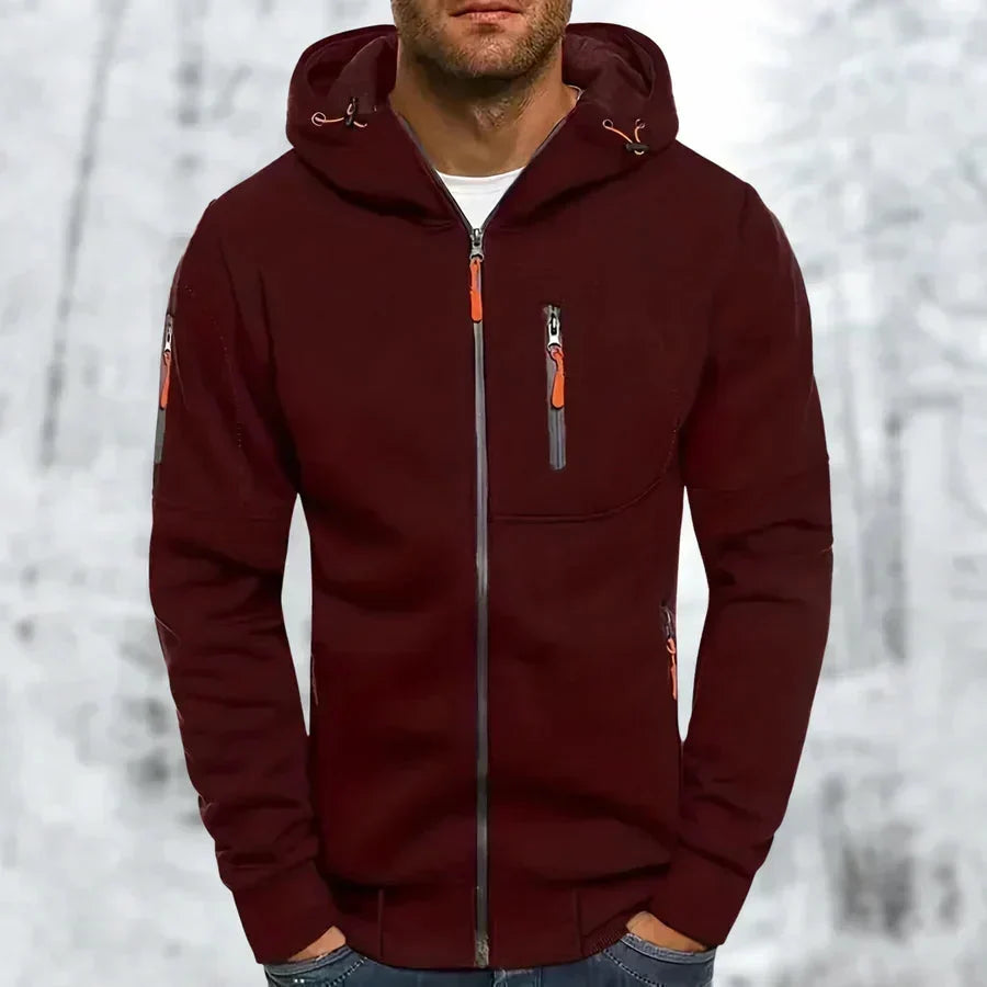 Model wearing the hoodie in dark burgundy with orange zip pulls and drawcords, set against a snowy woodland backdrop. 4