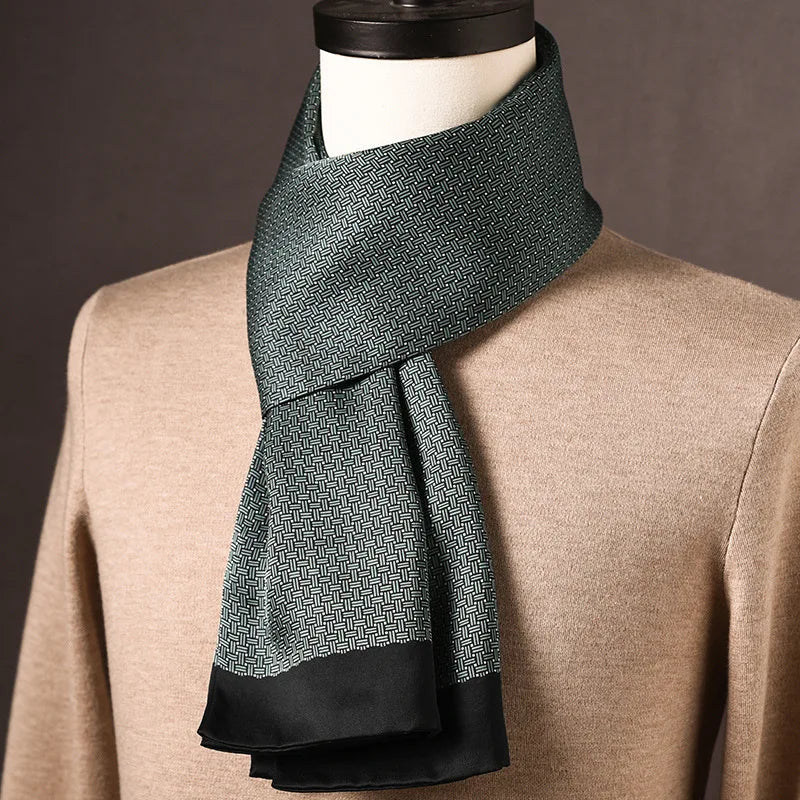 Dark green silk scarf with a fine woven-look pattern and a plain black edge, draped on a mannequin in a beige jumper. 23