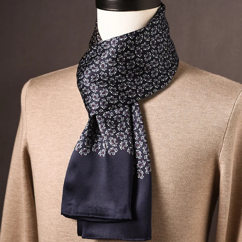 Navy silk scarf with a small white paisley pattern fading into a plain navy end, draped on a mannequin in a beige jumper. 26