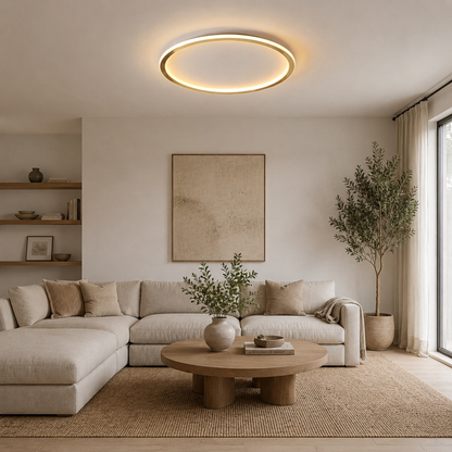 Gold ring light lit above a neutral living room with a corner sofa and round coffee table 6