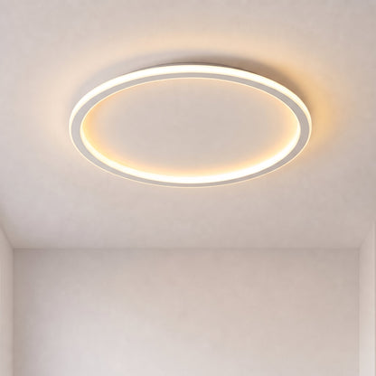 Slim white ring-shaped ceiling light switched on, glowing warmly against a plain pale ceiling with no furniture in view. 1