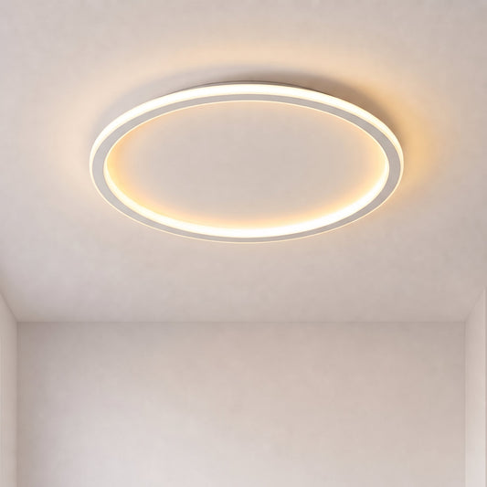 Slim white ring-shaped ceiling light switched on, glowing warmly against a plain pale ceiling with no furniture in view. 1