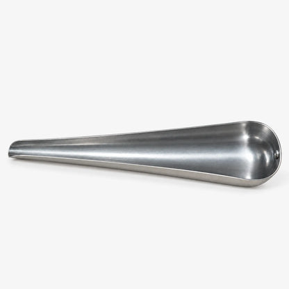 Empty tapered metal scoop lying on its side, showing the wide bowl at one end and the narrow pouring tip. 4