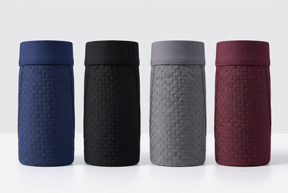 Four boxer shorts rolled into cylinders in navy, black, grey and burgundy, showing the textured weave 3