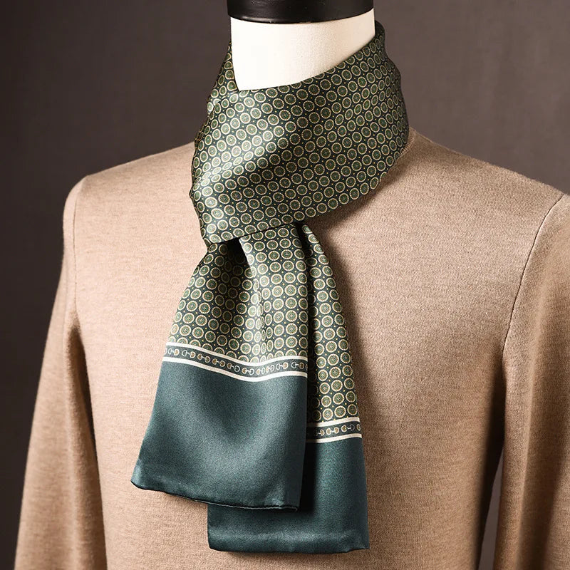 Green silk scarf with small cream and gold circular motifs and a plain green end panel, on a mannequin in a beige jumper. 8