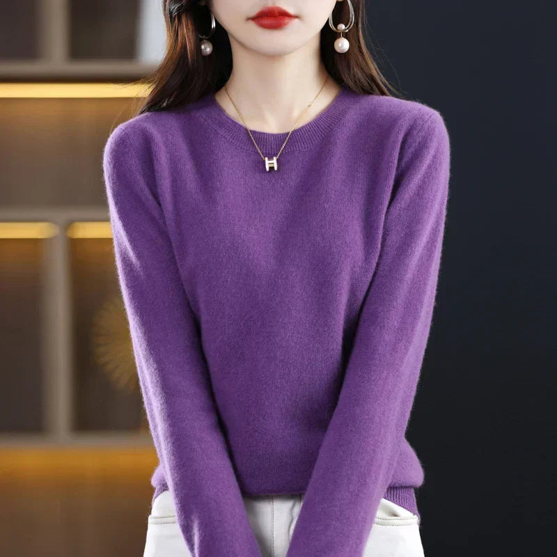 Purple round-neck jumper with a fluffy texture, worn tucked into white trousers with hands in pockets 12