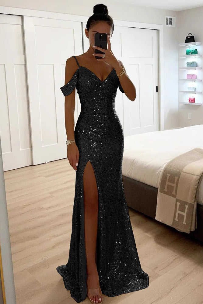 Model in the black sequin version, showing the fitted bodice, wrap neckline and long slit skirt 4