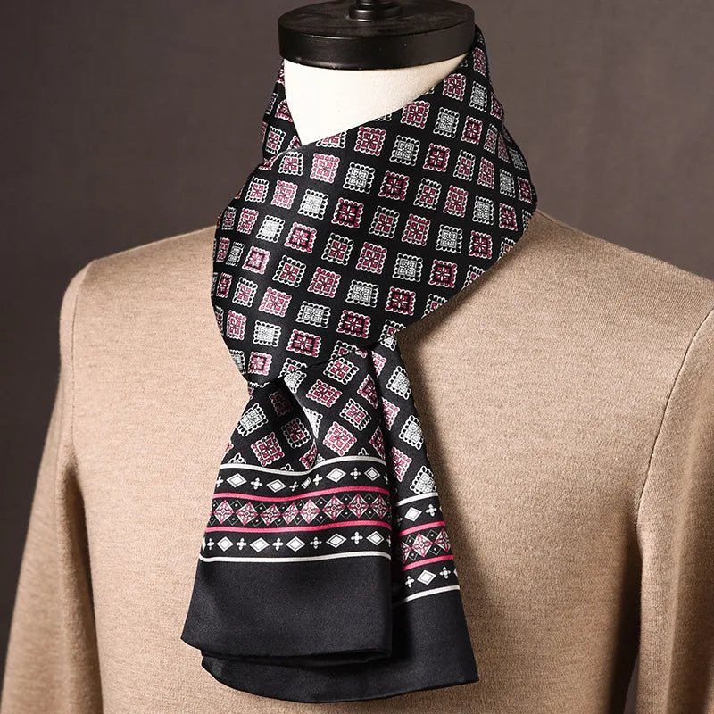 Black silk scarf with pink and white square geometric motifs and a patterned border, on a mannequin in a beige jumper. 15