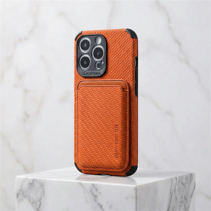 Orange textured case with card holder and black corner bumpers, displayed on a marble block 6