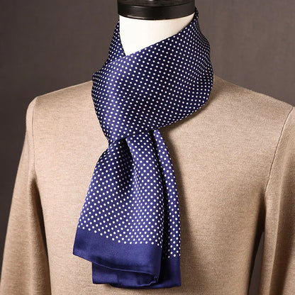 Navy silk scarf with white polka dots and plain navy ends, draped on a mannequin wearing a beige jumper. 2