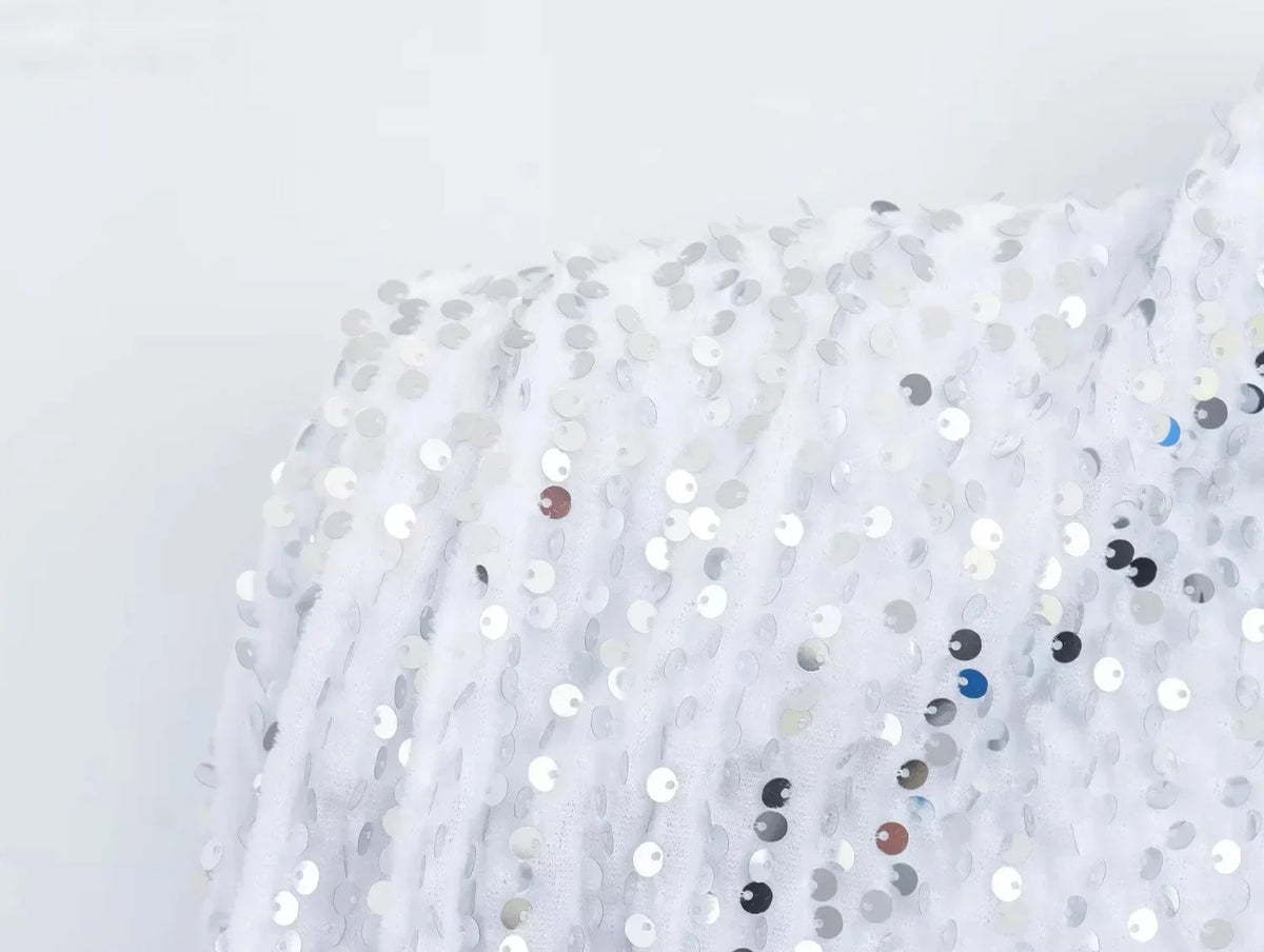 Close-up of the white sequinned fabric at the shoulder, with silver and tinted sequins 12