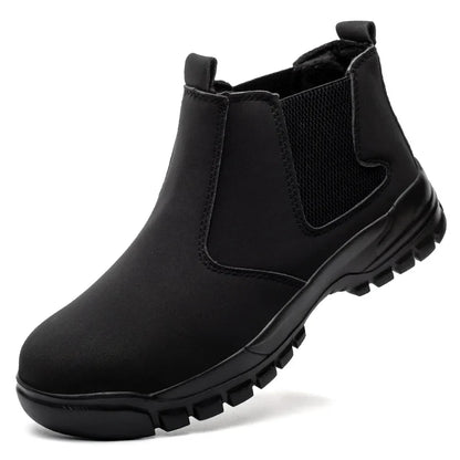 Black slip-on ankle boot on a white background, showing pull tabs, elastic panel and lugged sole 12