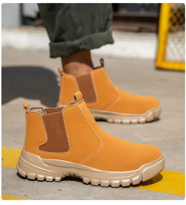 Tan boot in close-up on a concrete floor, showing orange stitching and knitted elastic side panel 9