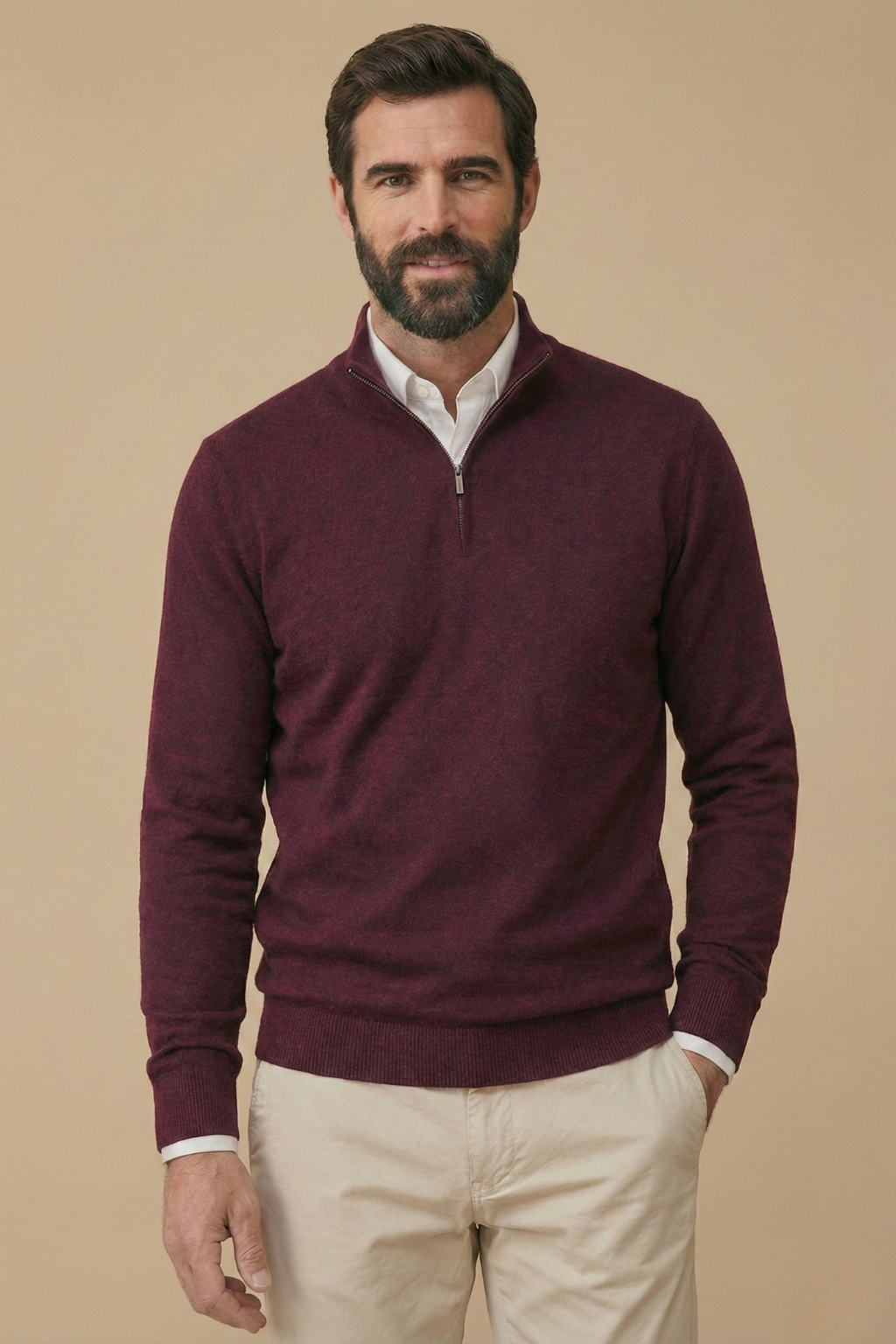 Smiling model wears the burgundy half-zip jumper over a white shirt, with one hand in his pocket 4
