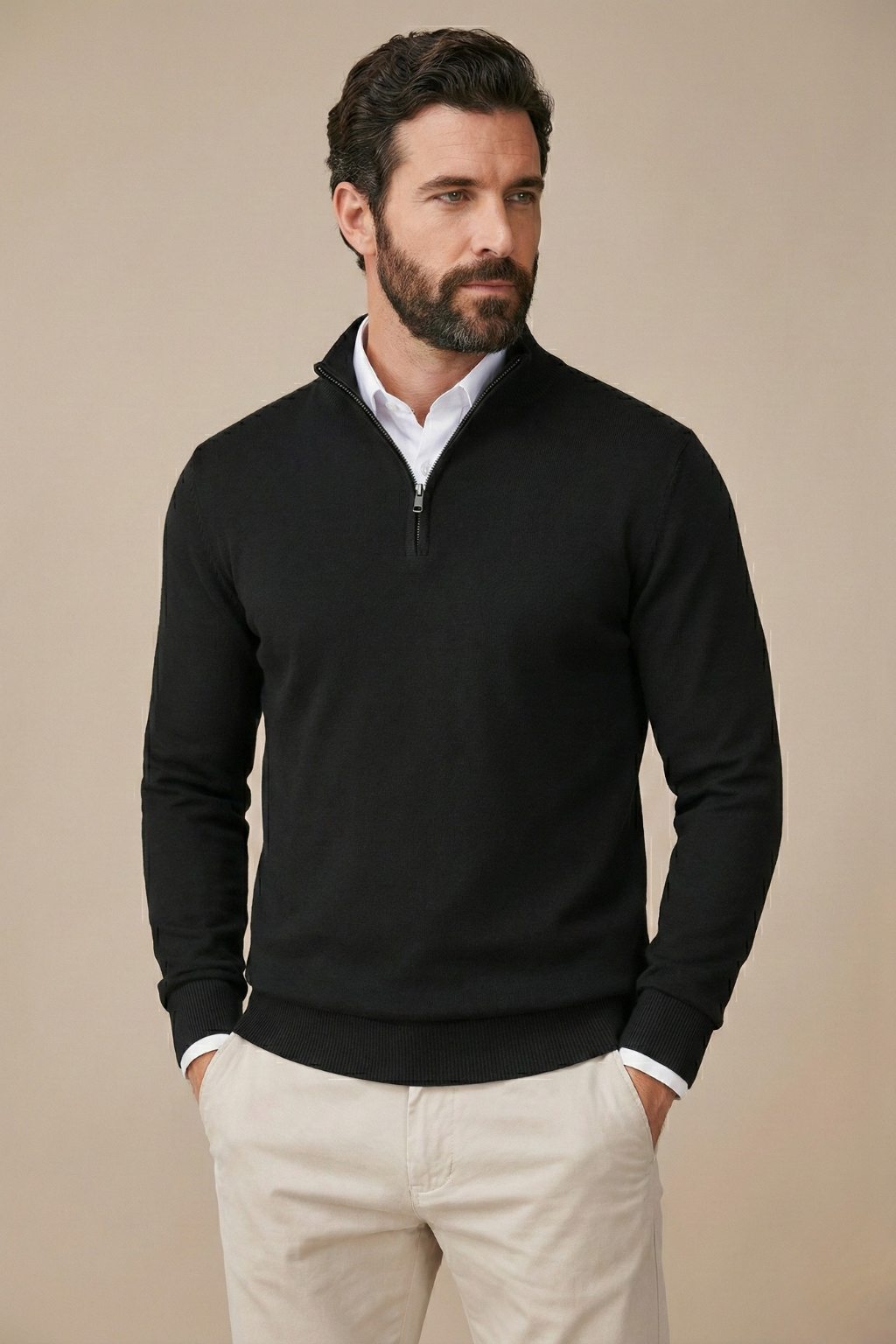 Bearded model wears the black half-zip jumper over a white shirt and stone trousers, front view 1