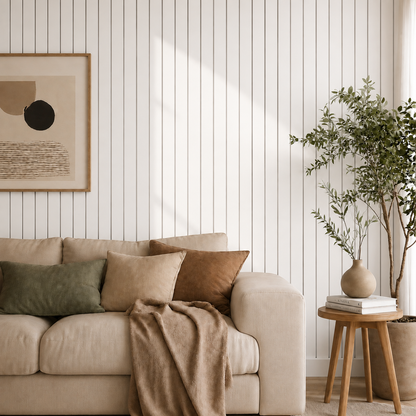 White slat wall behind a cream sofa with green and rust cushions, plant and side table 10