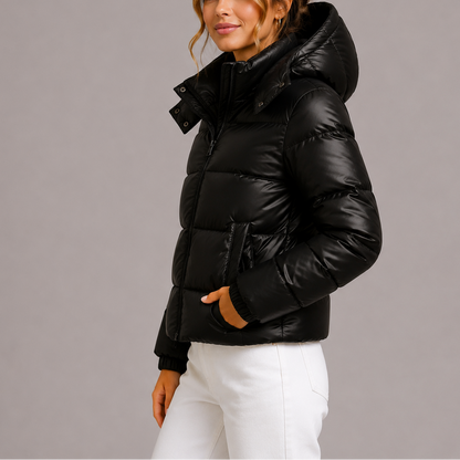Side view of a model in the black glossy puffer jacket with hand in pocket 3