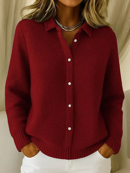 Textured collared jumper in deep burgundy red on a model, showing the white buttons, ribbed cuffs and ribbed hem. 3