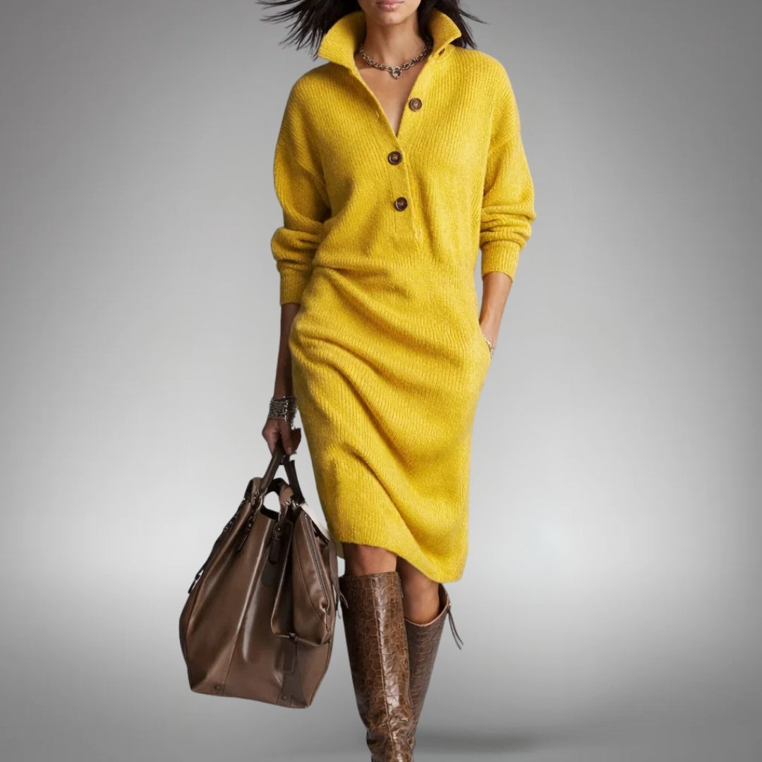 Model wearing the yellow knitted dress with a button placket and open collar, carrying a brown bag 10