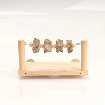 Front view of a wooden perch platform with two upright posts and a rod of bark slices and wooden beads. 1