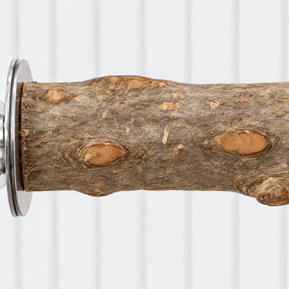 Close-up of the bark and knots on the wooden perch, with the round metal washer at the fixing end. 3