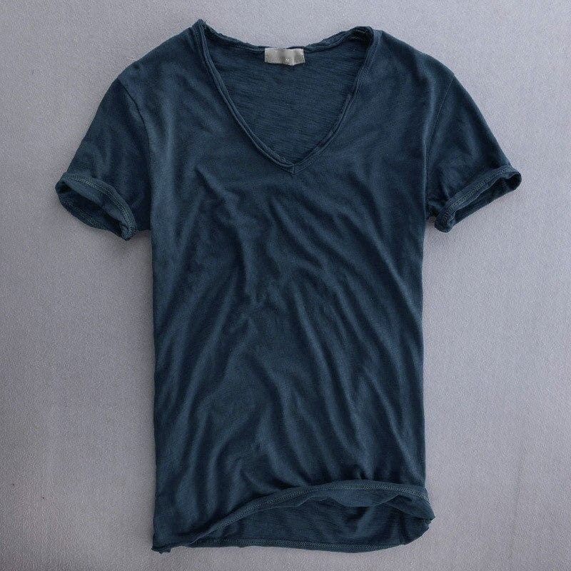 Navy blue version of the V-neck t-shirt laid flat, showing the slim cut, textured fabric and stitched rolled sleeve hems. 5
